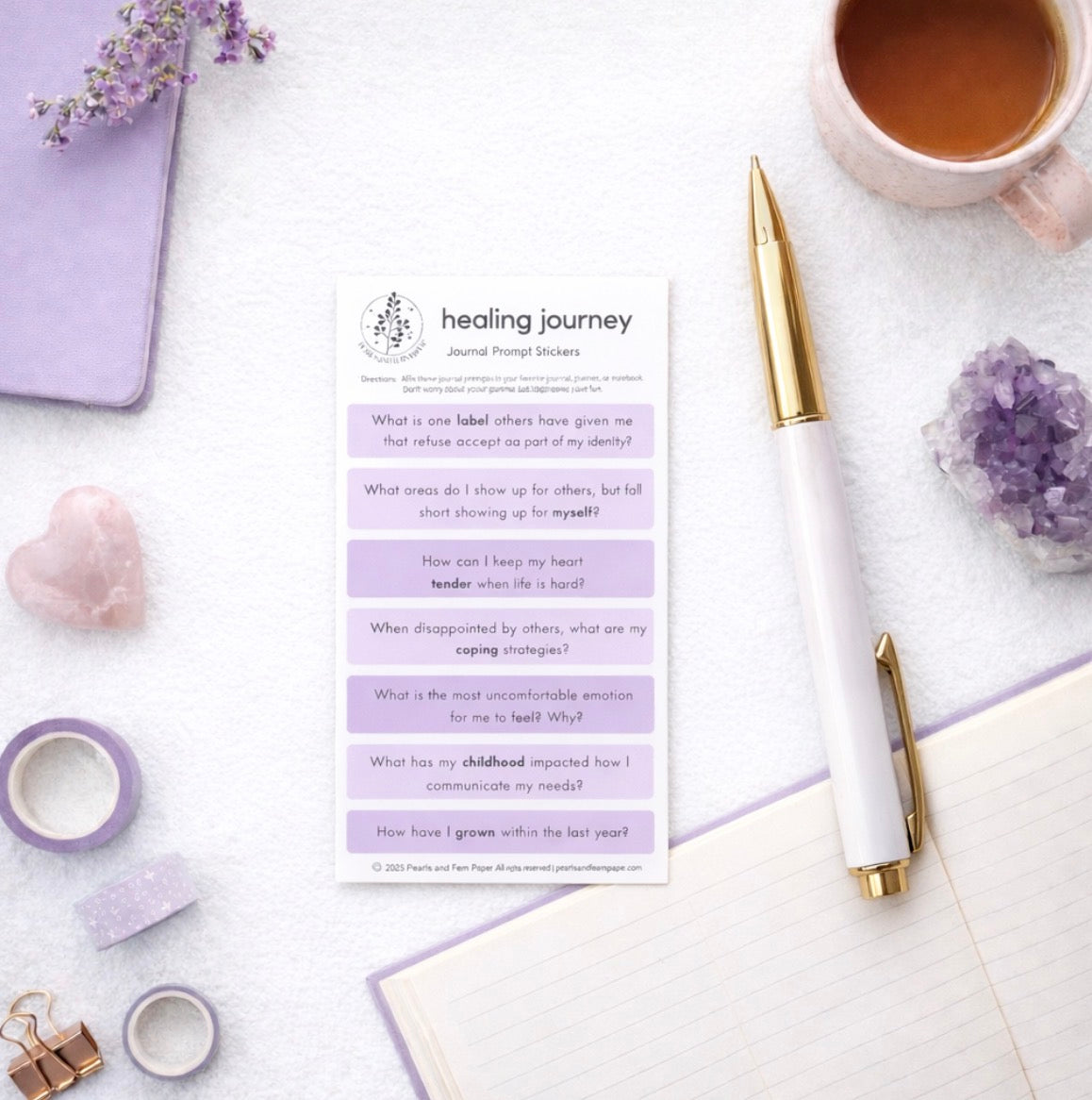 Healing journey worksheet on a desk with a cup of coffee, pen, and crystals.