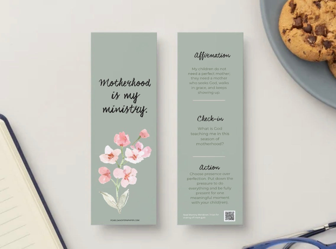 Two slim bookmarks for Mother's Day are displayed on a light surface. The left bookmark is sage green with the text 'Motherhood is my ministry.